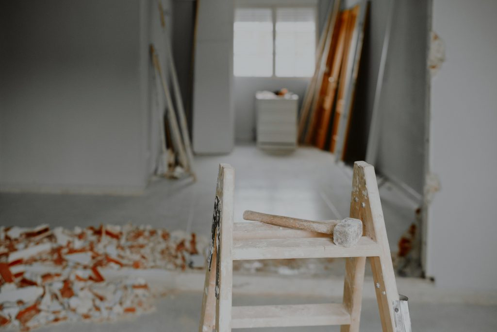 Vorschlaghammer auf einer Baustelle vor einer Treppe.